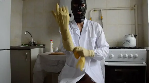 Fresh guy in the medical gown puts on three layers of gloves clips Clips